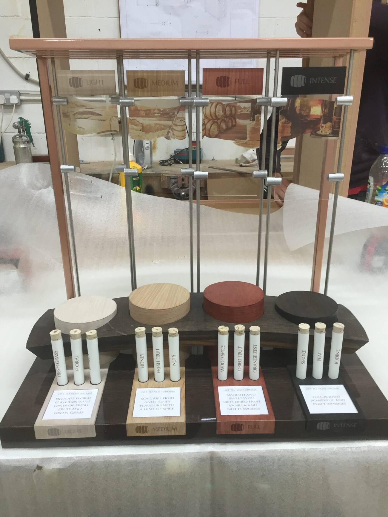 Tasting display stand with suspended miniature spirit bottles